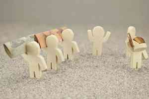 Kleine Figuren mit Geldscheinen und Münzen